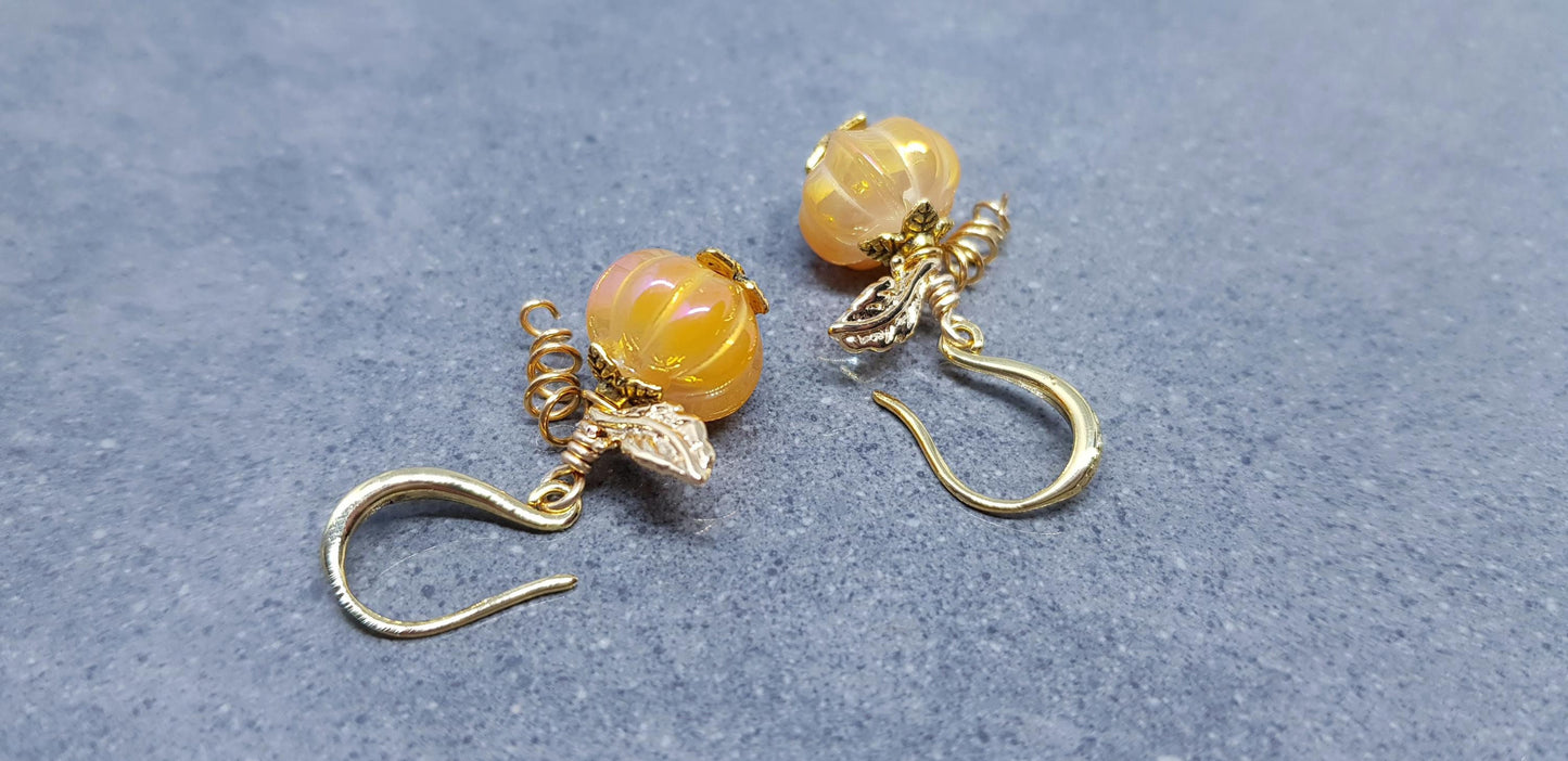 Glass orange pumpkins with gold plated components, leaves and tendrils with hypoallergenic ear wires.